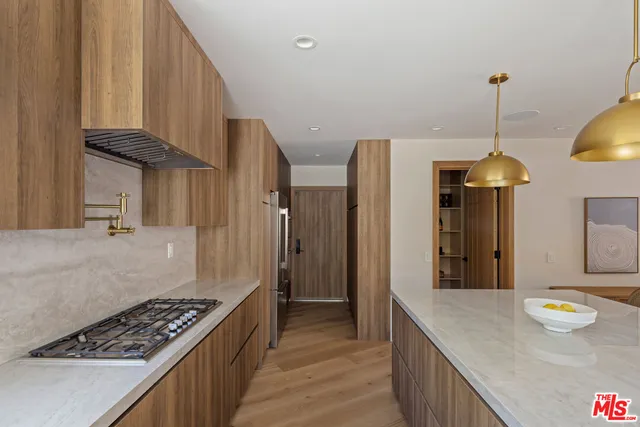 a kitchen with stainless steel appliances granite countertop a stove and a refrigerator