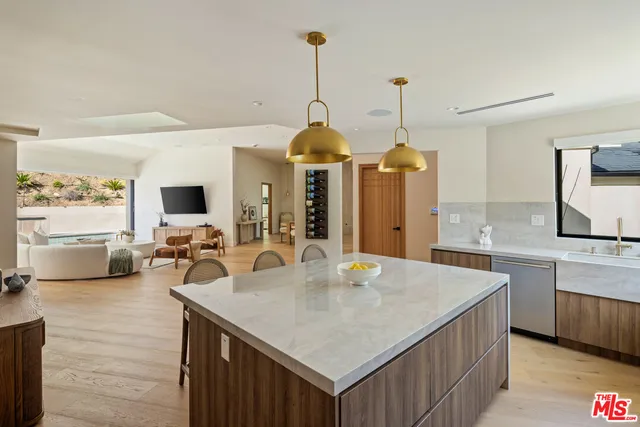 a kitchen with sink refrigerator and dining table