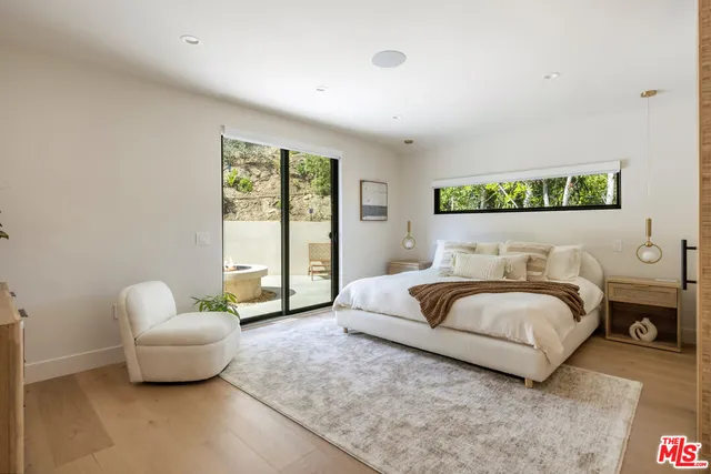 a bedroom with bed and a couch