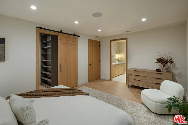 a bedroom with furniture and a potted plant