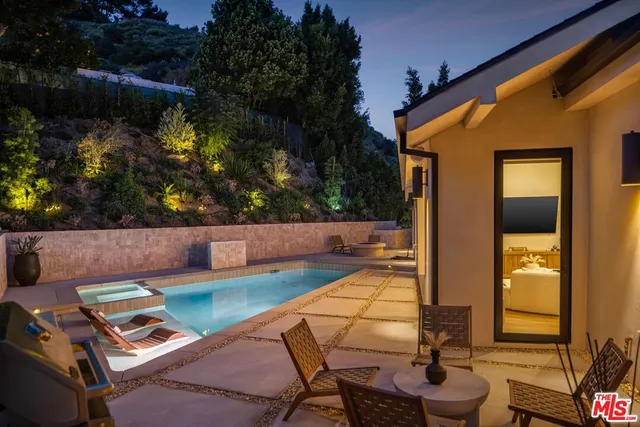 a view of backyard of house with seating space