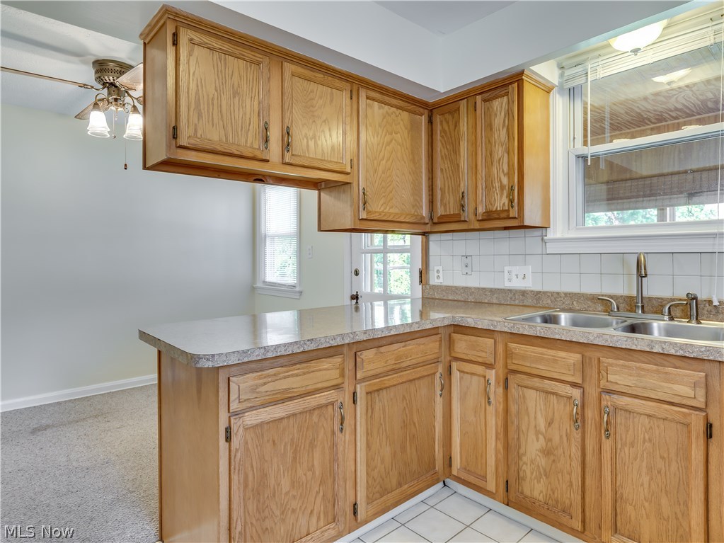 1149 Winston Road Cleveland, OH 44121 - Photo 9 of 28 Ah, now we have the heartbeat of the home, the kitchen. Oak cabinets, ceramic floor, SS sink and faucet.