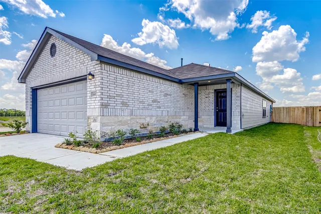a view of a house with brick walls and a yard