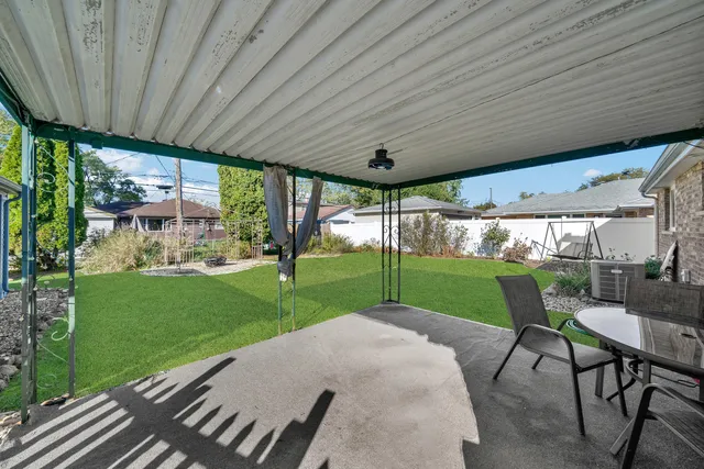 a view of a porch with furniture and garden