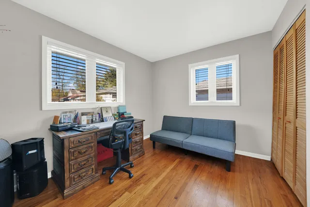 a livingroom with workspace and a window