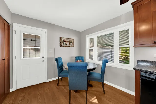 a dining room with furniture and wooden floor
