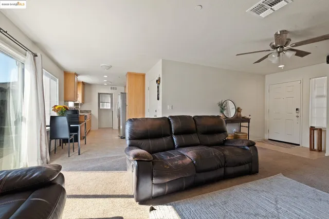 a living room with furniture and a dining table