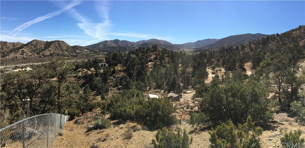 7842 Jack Rabbit Pinon Hills, CA 92372 - Photo 1 of 1 a view of a house with a mountain in the background