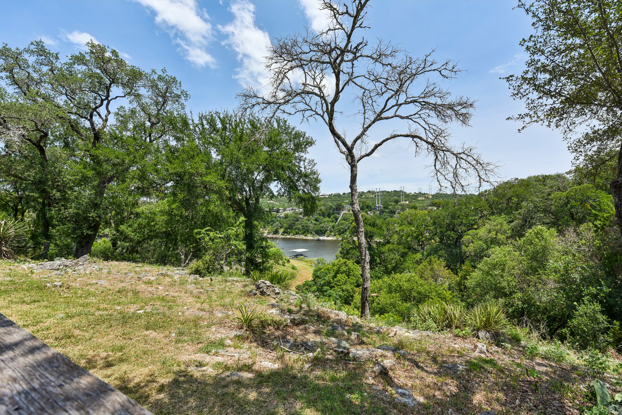 2203 Improver Road Spicewood, TX 78669 - Photo 27 of 38 Panoramic lake views from this verdant, elevated parcel, offering tranquility and natural beauty.