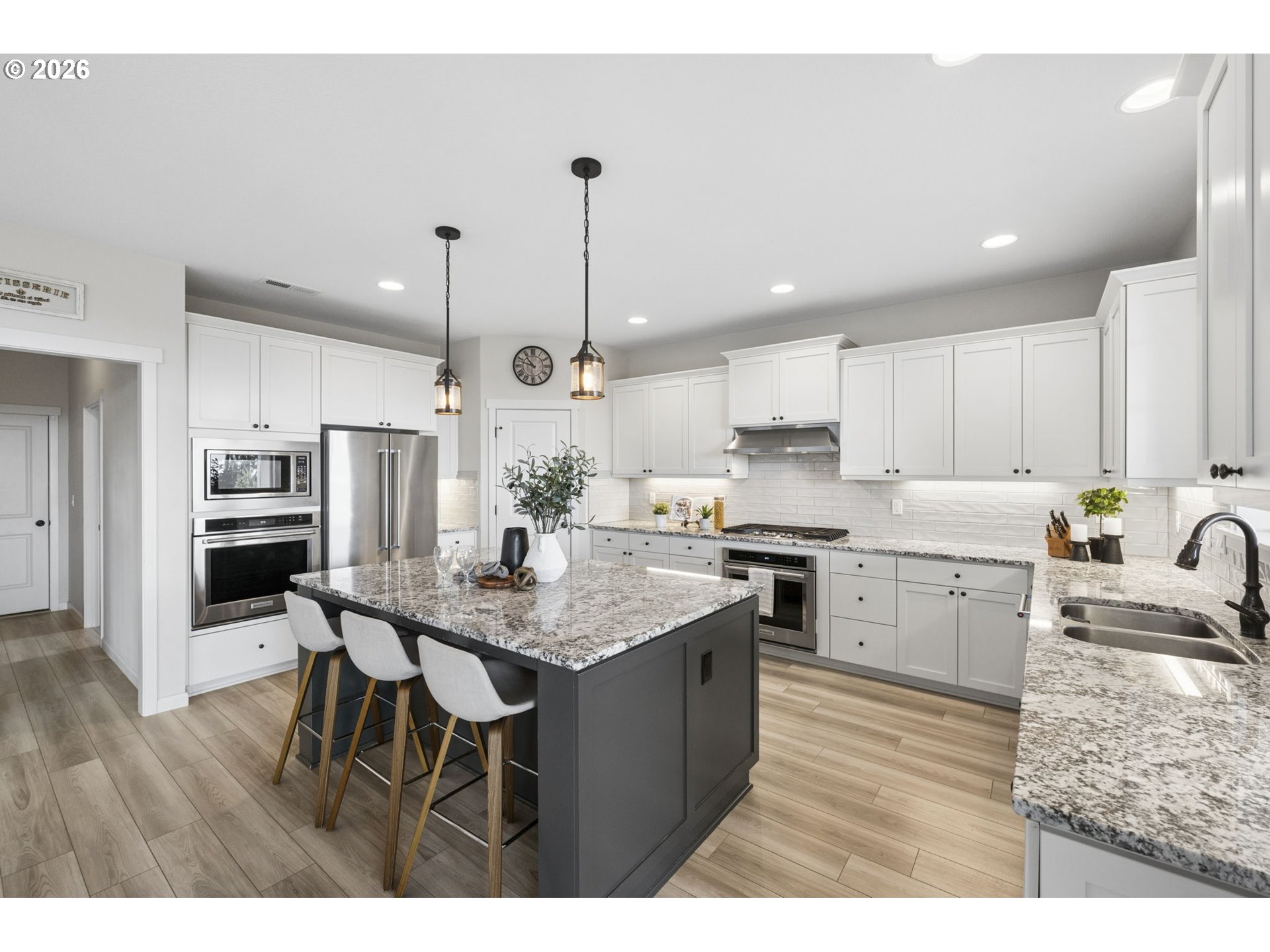 18255 Southeast Vista View Court Sandy, OR 97055 - Photo 13 of 48 a kitchen with stainless steel appliances kitchen island granite countertop a sink refrigerator and cabinets