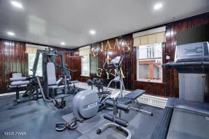 a view of a dining room with furniture a chandelier and kitchen view