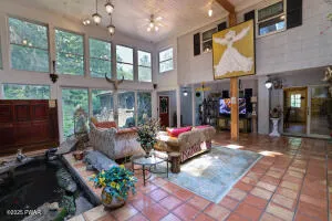 a view of a hallway with wooden floor and furniture