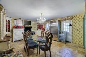 a bedroom with a bed and a mirror on the dresser