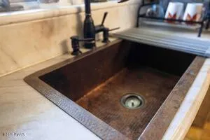 a living room with furniture a fireplace and large windows
