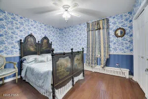 a bed sitting in a bedroom next to a window