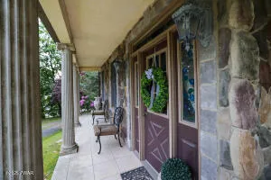 a living room with fireplace furniture and a large window
