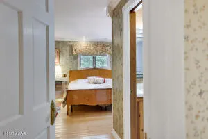 a bedroom with bed and a mirror