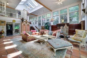 a living room with furniture and a floor to ceiling window