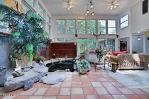 a view of a dining room with furniture and chandelier