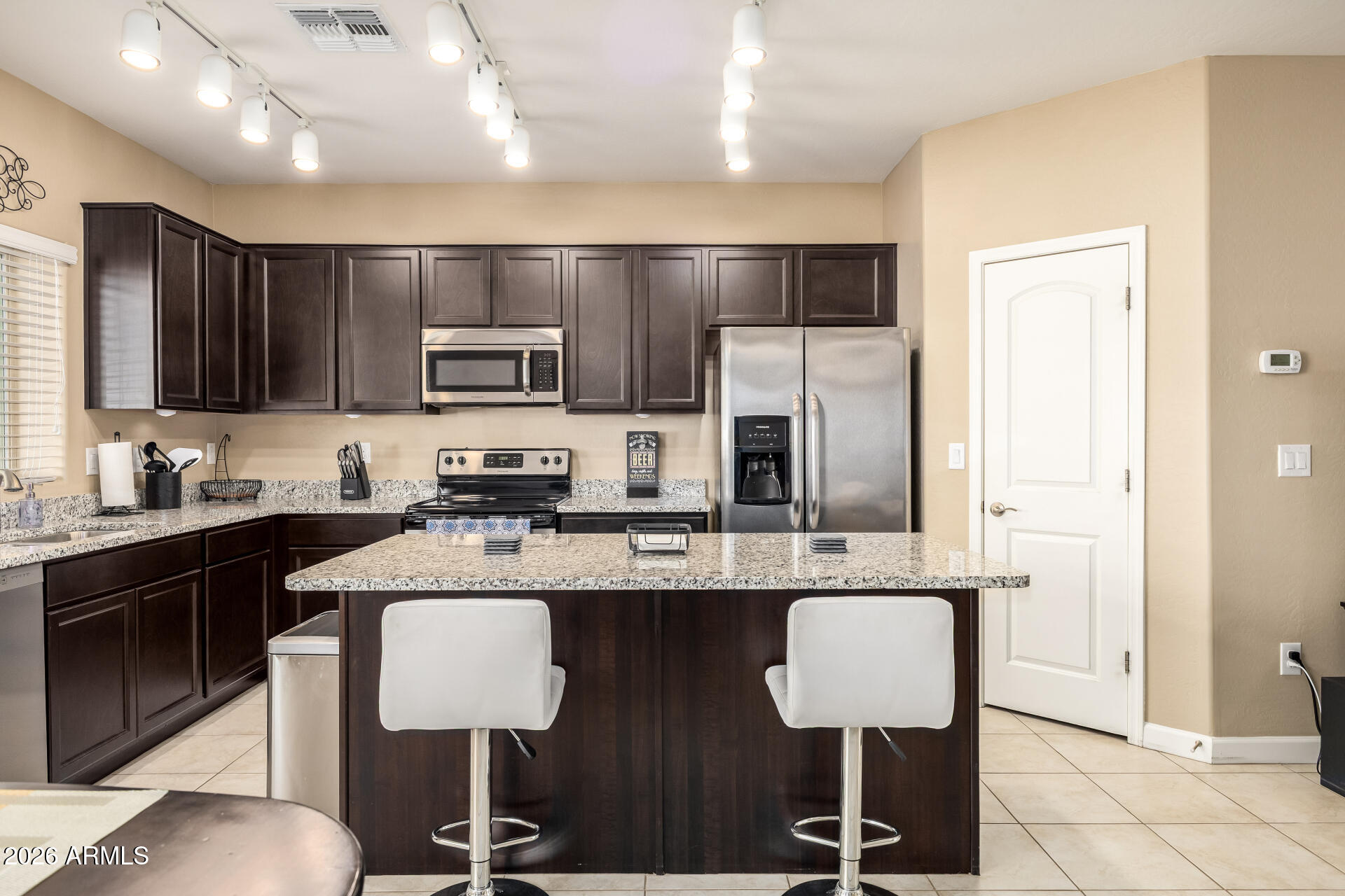2150 West Alameda Road, Unit 1181 Phoenix, AZ 85085 - Photo 10 of 46 a kitchen with stainless steel appliances granite countertop a stove a sink dishwasher a refrigerator and a microwave