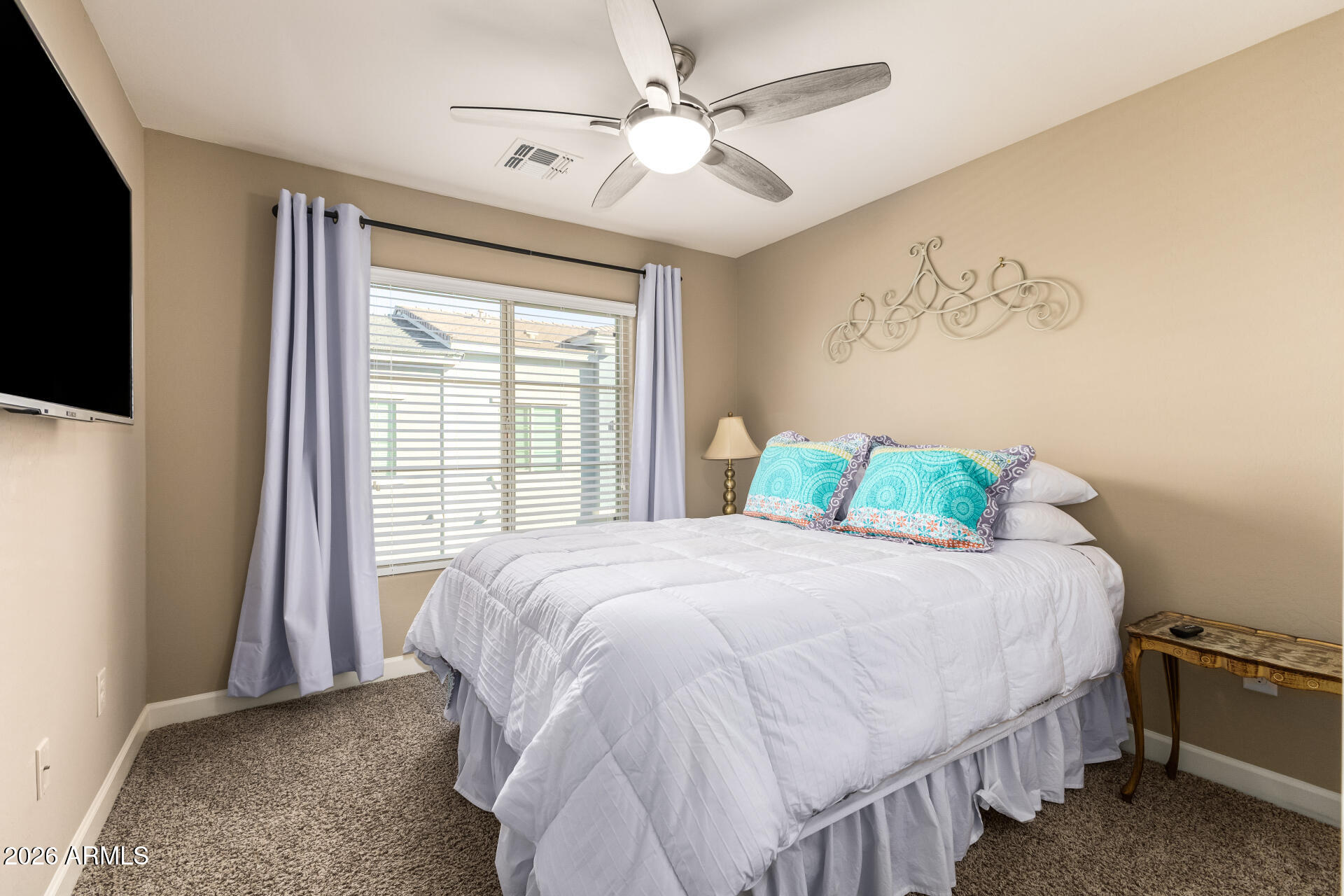 2150 West Alameda Road, Unit 1181 Phoenix, AZ 85085 - Photo 18 of 46 a bedroom with a bed and a chandelier