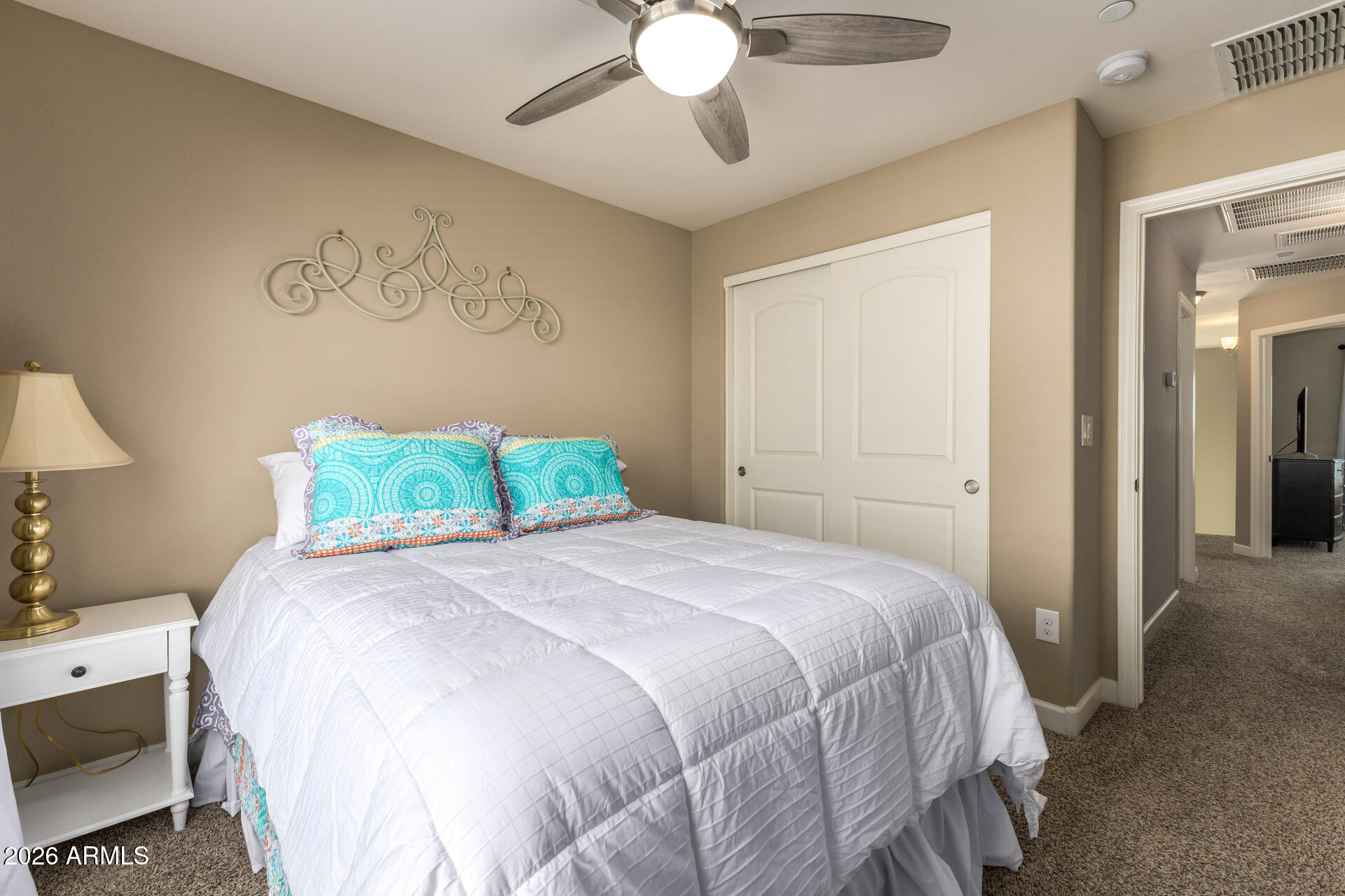 2150 West Alameda Road, Unit 1181 Phoenix, AZ 85085 - Photo 19 of 46 a bedroom with a bed and a chandelier
