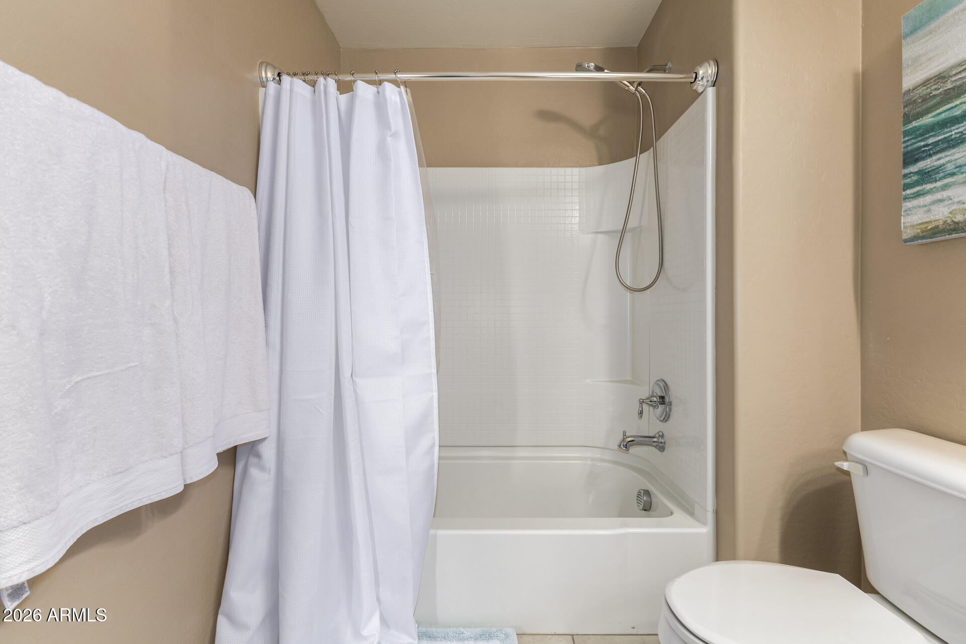 2150 West Alameda Road, Unit 1181 Phoenix, AZ 85085 - Photo 21 of 46 a bathroom with a shower curtain and a bathtub