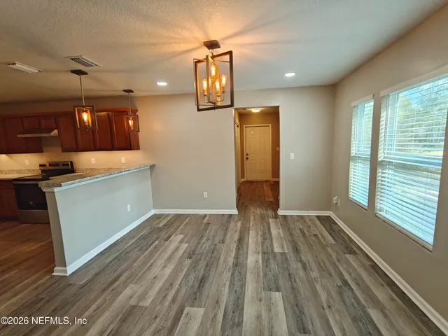 a kitchen with a sink cabinets and a window