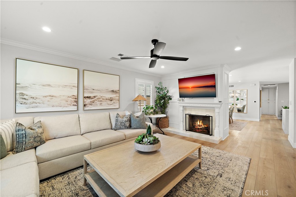 8741 La Roca Avenue Fountain Valley, CA 92708 - Photo 6 of 50 Formal living room with fireplace flows into dining room, family room, and kitchen