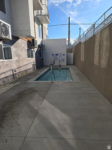 2085 North Main Street, Unit 412 Sunset, UT 84015 - Photo 12 of 14 Outdoor swimming pool with integrated accessibility lift, surrounded by concrete decking