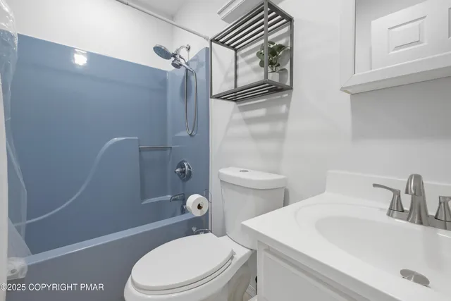 a white toilet sitting next to a bathroom sink