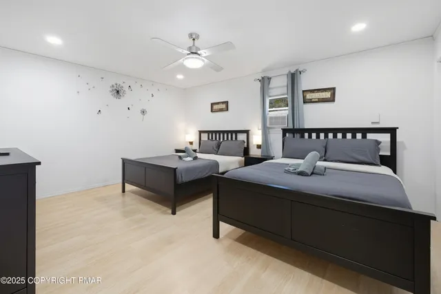 a spacious bedroom with a bed and a chandelier