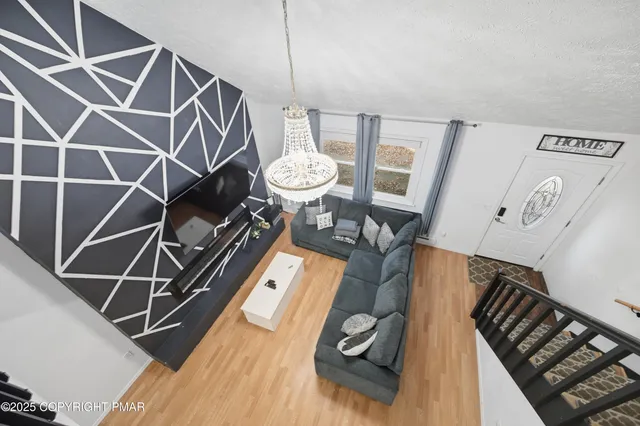 a view of a room with wooden floor and cabinets