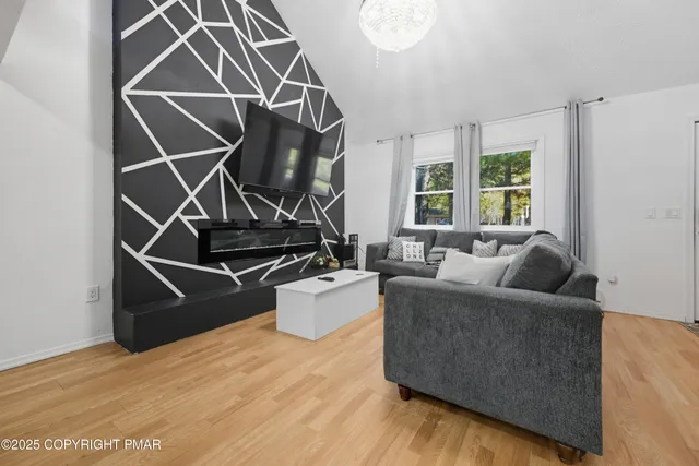 a living room with a couch and a floor to ceiling window