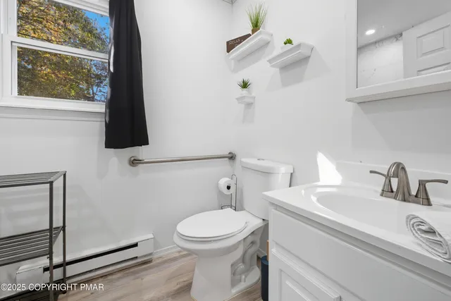 a bathroom with a sink a toilet and a mirror