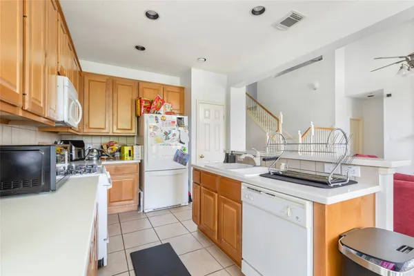 a kitchen with a sink appliances and cabinets