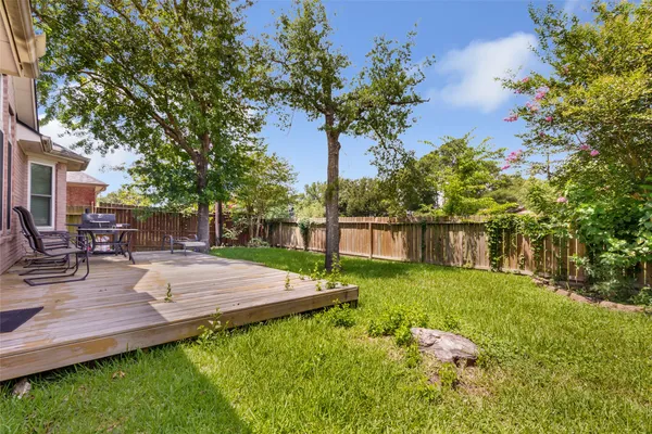 a view of backyard with house and outdoor seating
