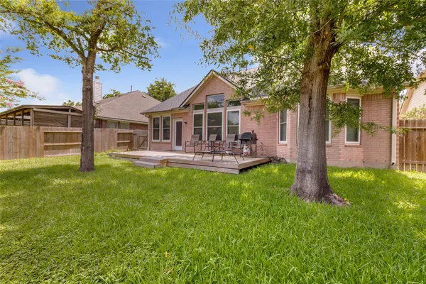 a front view of a house with a yard table and chairs