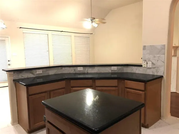 a kitchen with a sink cabinets and wooden floor