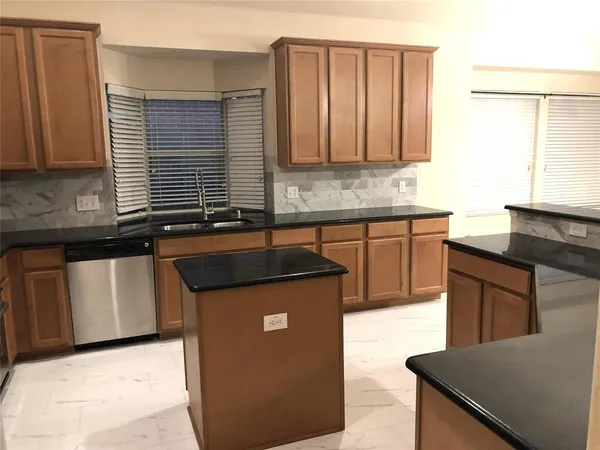 a kitchen with stainless steel appliances granite countertop a sink stove and cabinets