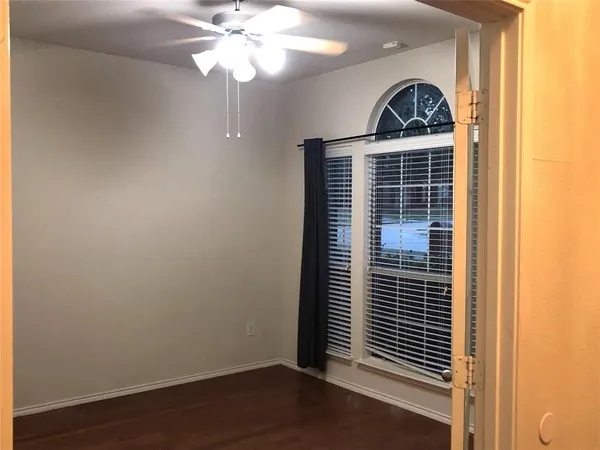 a bathroom with a toilet and a shower curtain