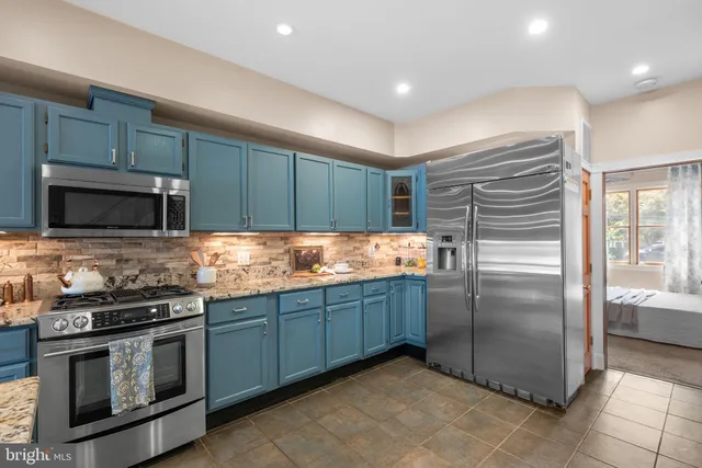 a kitchen with granite countertop stainless steel appliances and wooden cabinets