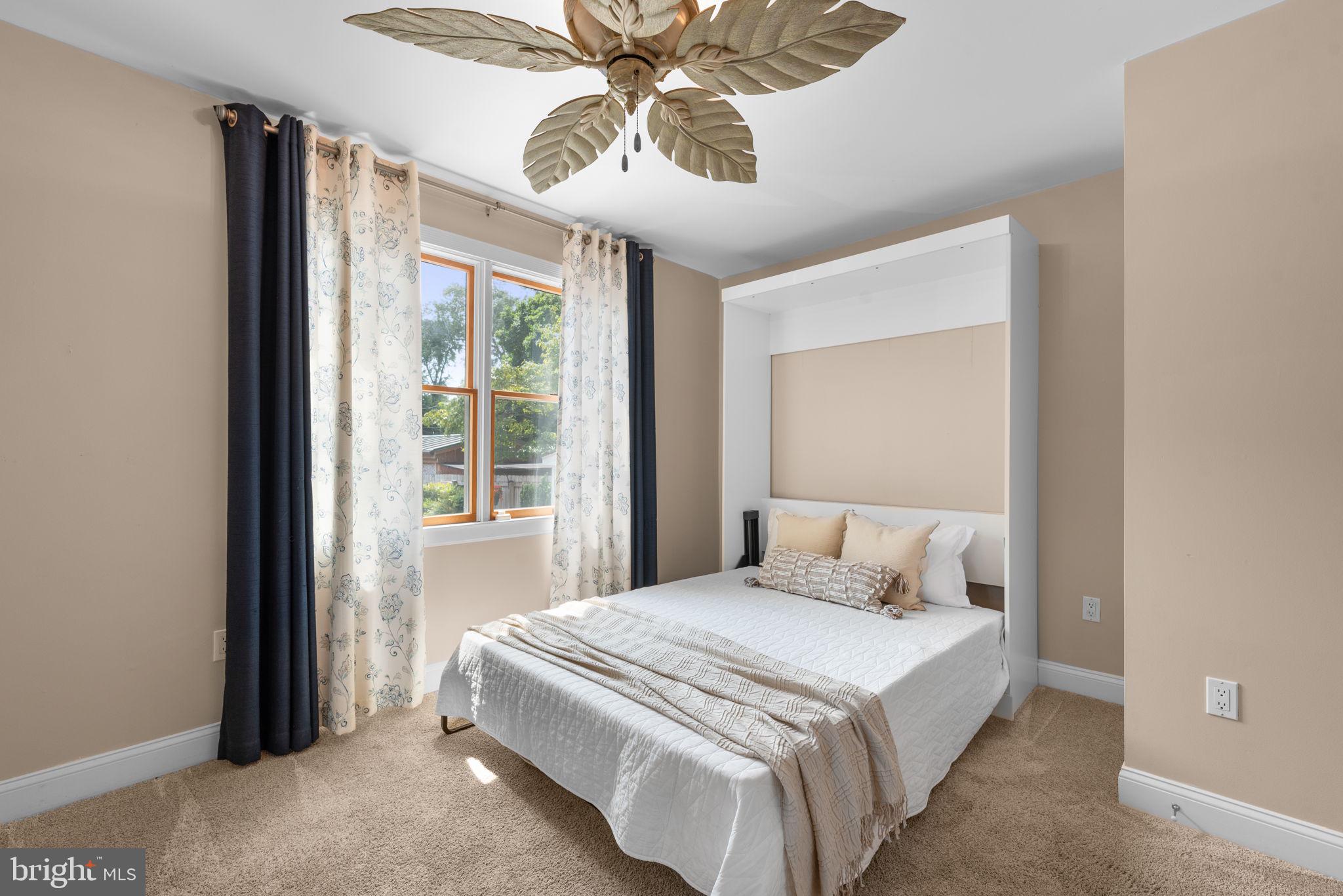 7674 Pine Knob Road Pasadena, MD 21122 - Photo 16 of 59 a bedroom with a bed and a chandelier