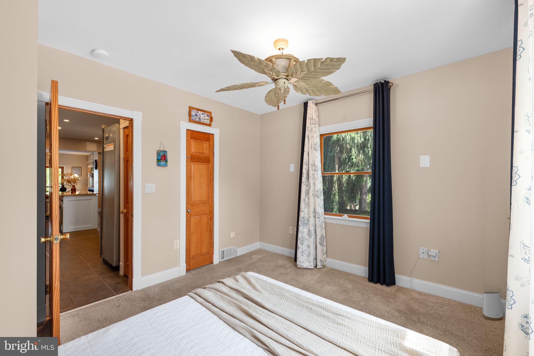 7674 Pine Knob Road Pasadena, MD 21122 - Photo 17 of 59 a bedroom with a bed and a chandelier