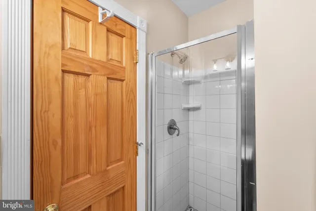 a bathroom with a glass shower door