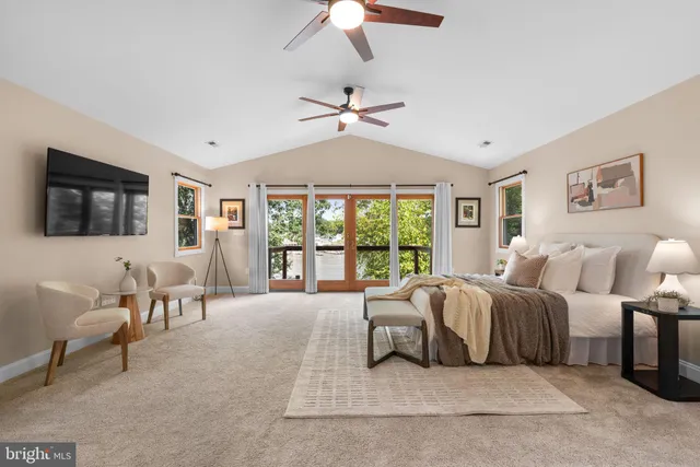 a living room with a balcony furniture and a chandelier