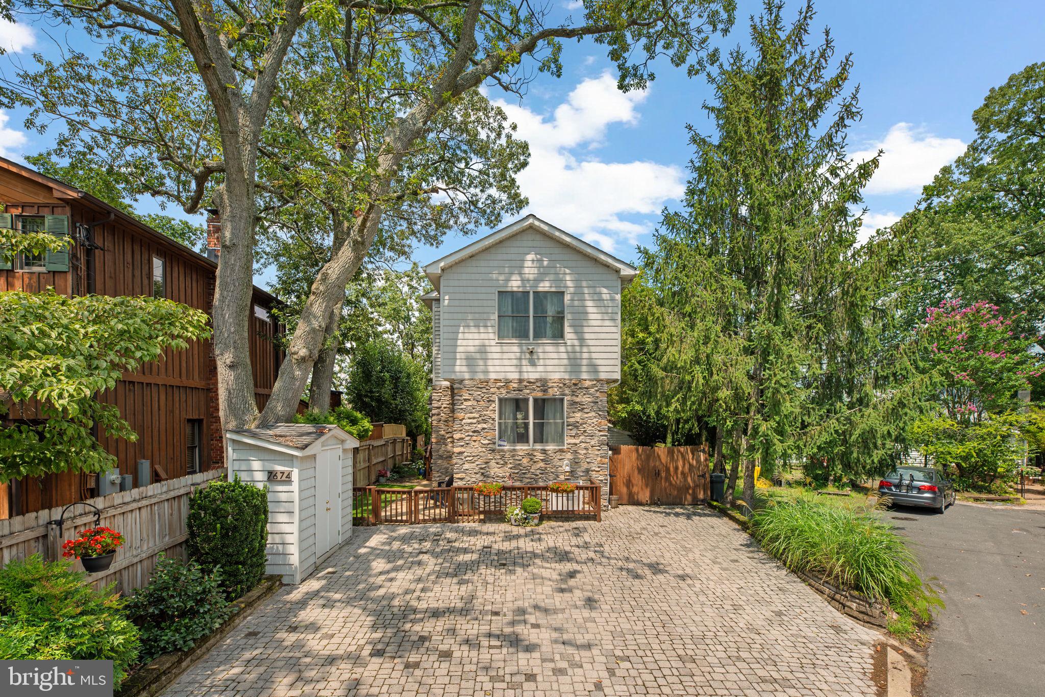 7674 Pine Knob Road Pasadena, MD 21122 - Photo 2 of 59 a front view of a house with a garden