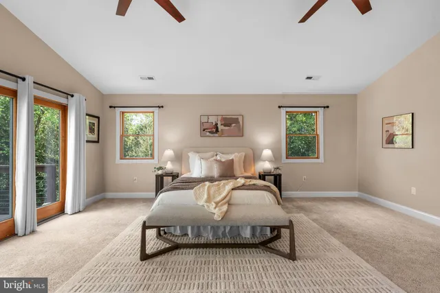 a bedroom with a bed a chandelier and a window