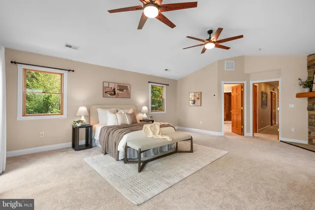 a spacious bedroom with a bed and window
