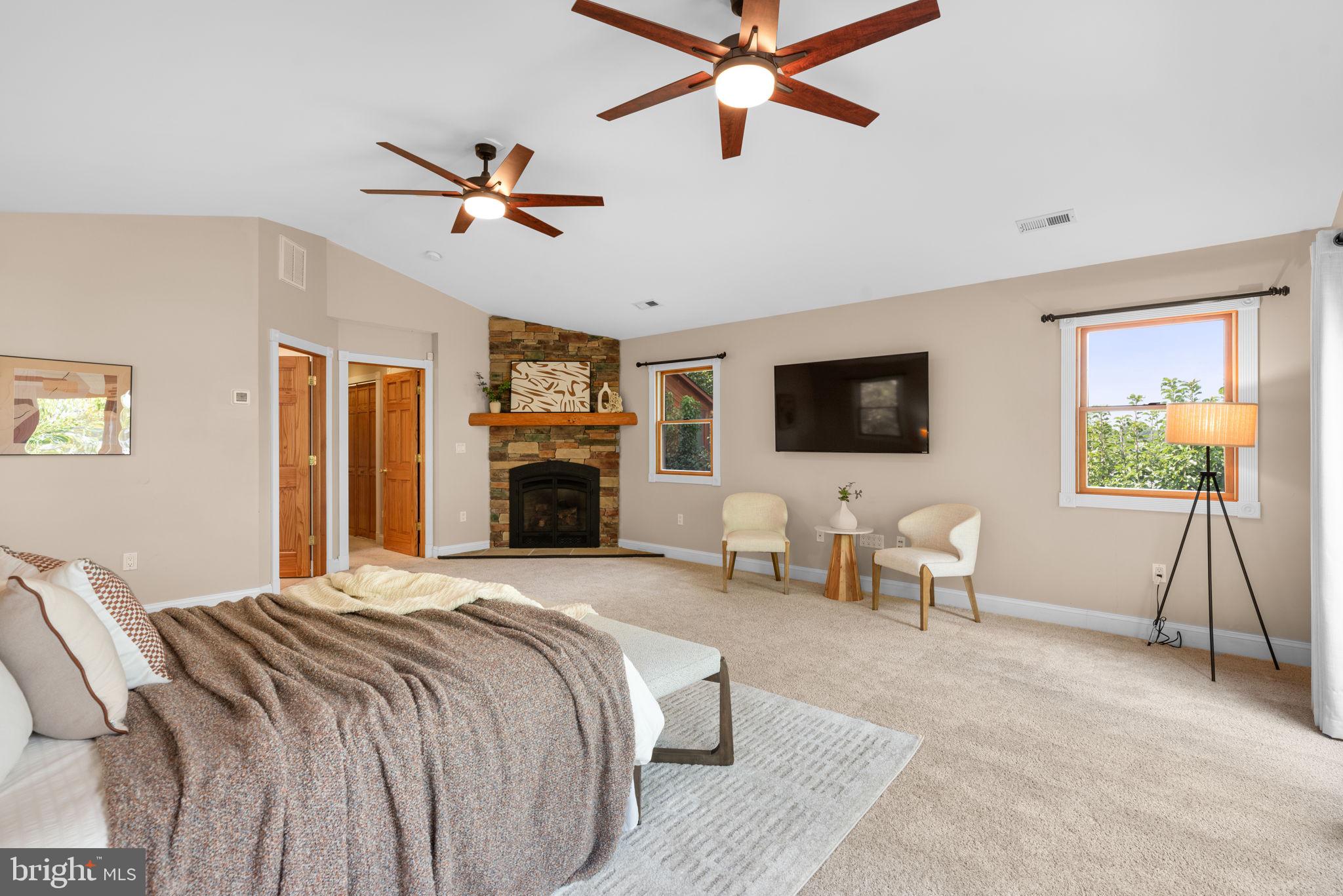 7674 Pine Knob Road Pasadena, MD 21122 - Photo 24 of 59 a spacious bedroom with a bed and a flat screen tv
